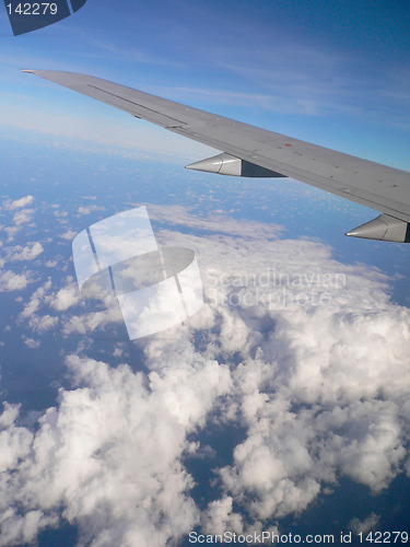 Image of Aeroplane wing over clouds.