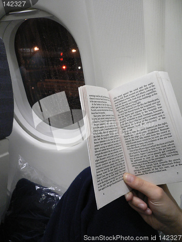 Image of Reading a book on the plane