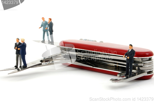 Image of business people on penknife
