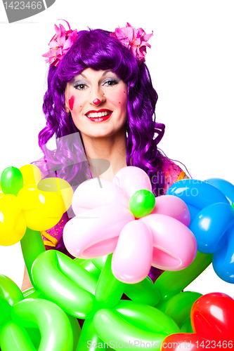 Image of female clown with colorful balloon flowers