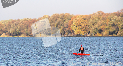 Image of Man in a red canoe