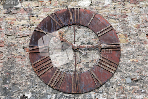 Image of Rusty old clock on the wall