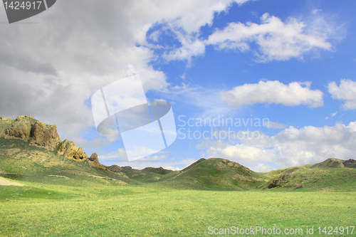 Image of landscape in early spring in the field, cloudy sky  mountain