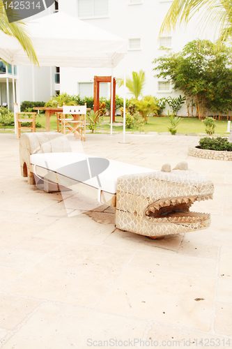 Image of Home exterior patio with handcraft wooden sofa with an aligator 