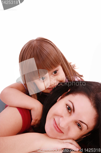 Image of A portrait of a mother and her baby girl lying on the floor and 