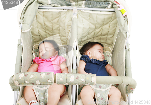 Image of twins sleeping in their stroller