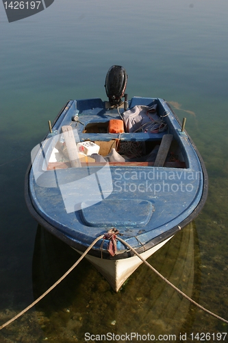 Image of A wooden rowing boat tide down