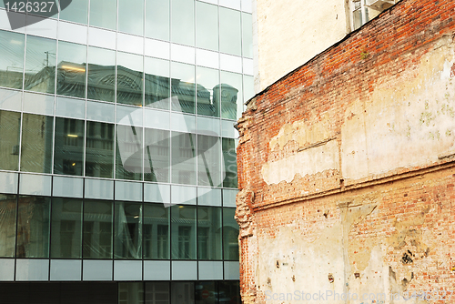 Image of modern building and old brick wall