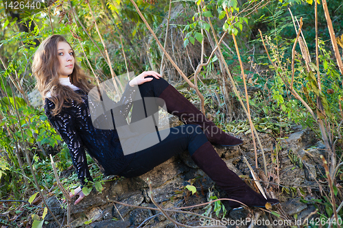 Image of Girl sitting on a stones