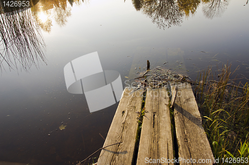 Image of Broken and hollow in water abandoned wooden bridge