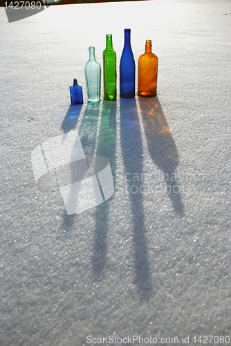 Image of Colored bottles on snow 