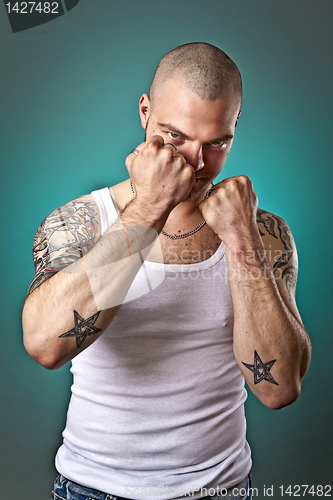 Image of man with tattoos