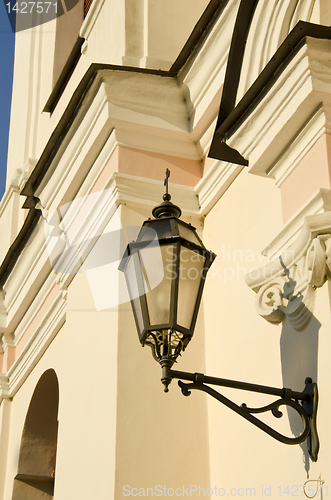 Image of Metal illuminator on ancient wall of  building.