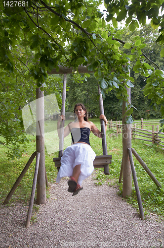 Image of Wooden vintage swing With A Lady