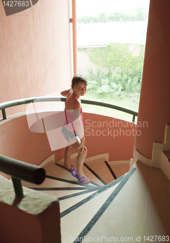 Image of Portrait of a beautiful young girl on  staircase