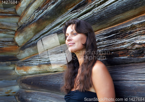 Image of Beautiful girl near the wooden wall