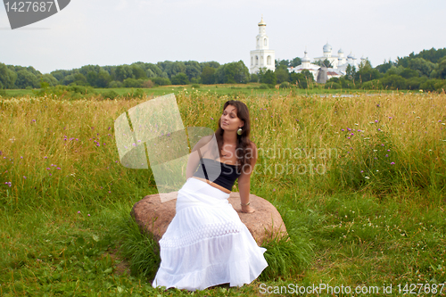 Image of Girl Sits On flowers Field Stone