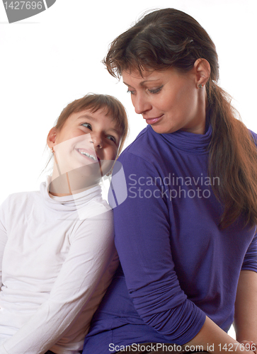 Image of smiling mother and daughter look at each other