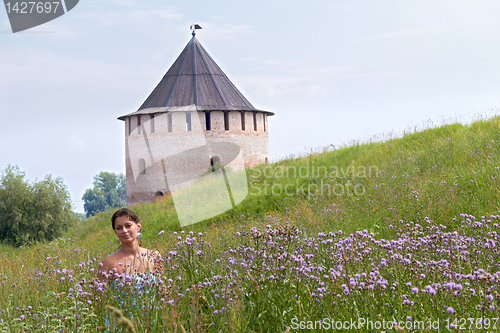 Image of Woman in field on castle background