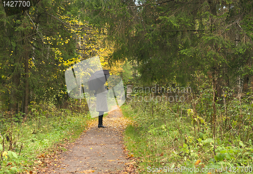 Image of women vaiting long alley at fall autumn season