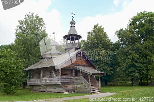 Image of aging wooden chapel in village