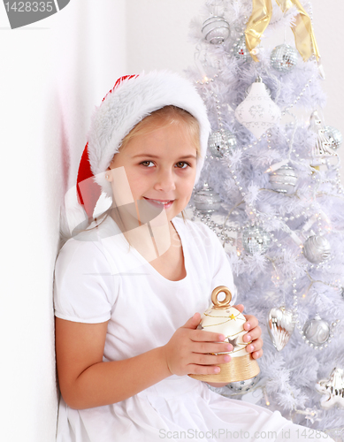 Image of Girl holding Christmas bell
