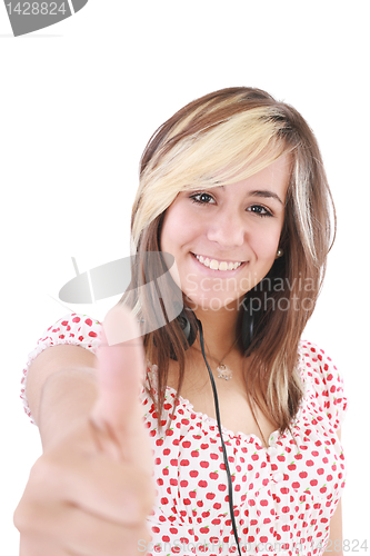 Image of Smiling beautiful woman with thumbs up. Focus on the girl