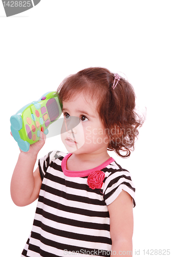 Image of Smiling cute little girl in dress calling by telephone