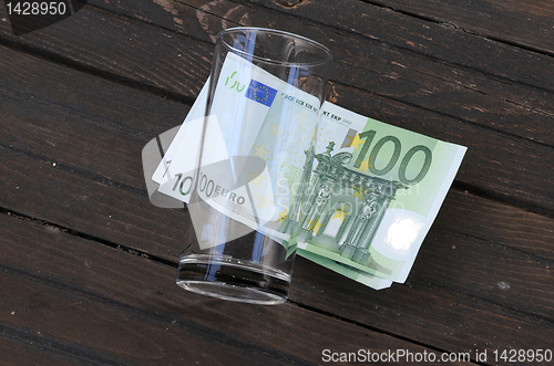 Image of Empty Glass and One Hundred Euro Banknotes