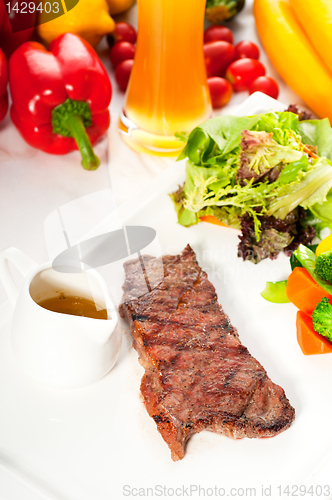 Image of juicy BBQ grilled rib eye ,ribeye steak and vegetables