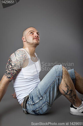Image of man with tattoos