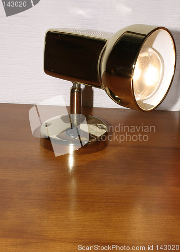 Image of lit bedside lamp