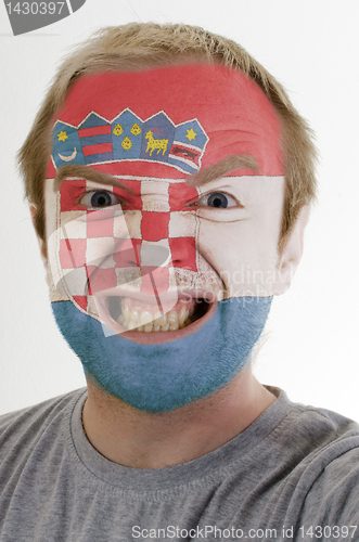 Image of Face of crazy angry man painted in colors of  flag