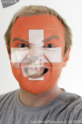 Image of Face of crazy angry man painted in colors of Schwitzerland flag