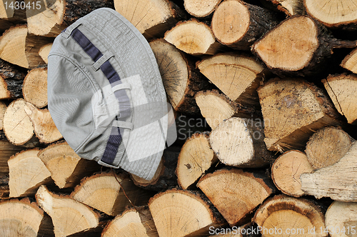 Image of Stack of Firewood and Hat