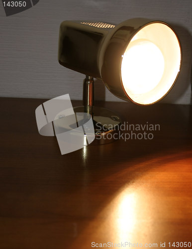 Image of lit bedside lamp