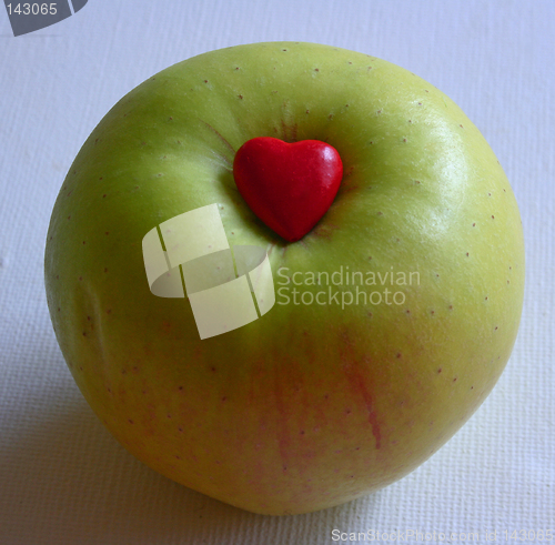 Image of tiny red heart in apple