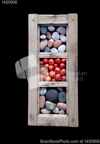 Image of Window frame with stones and apples 