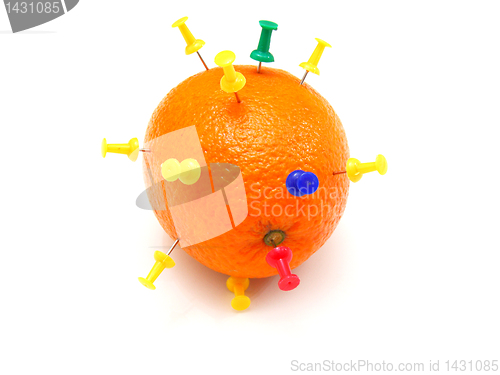 Image of Isolated colourful office pins thrust in an orange