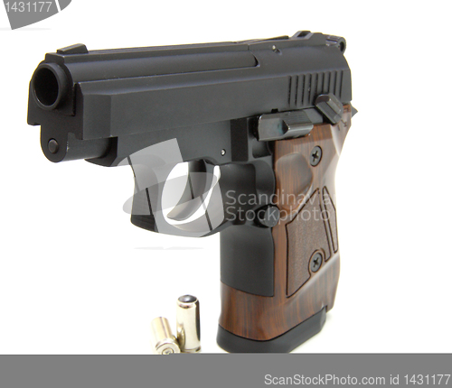 Image of The close up of a pistol a target and cartridges is isolated on 