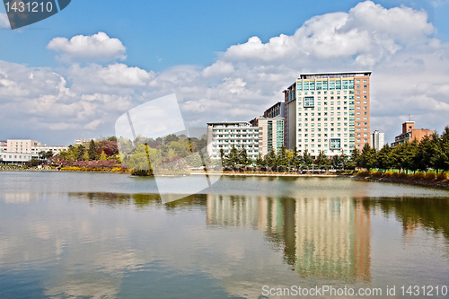 Image of Modern apartment buildings over lake in a university campus