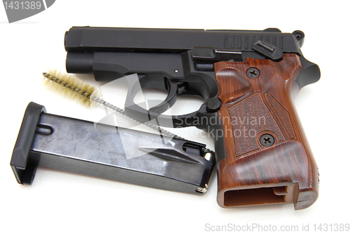 Image of The close up of a pistol a target and cartridges is isolated on 