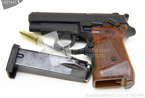 Image of The close up of a pistol a target and cartridges is isolated on 