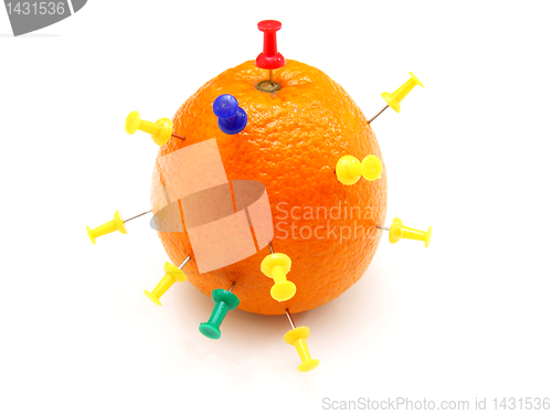 Image of Isolated colourful office pins thrust in an orange