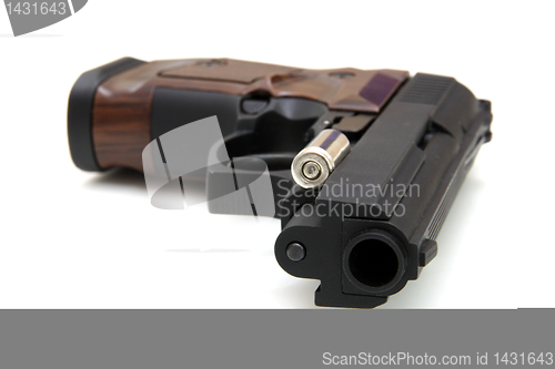 Image of The close up of a pistol a target and cartridges is isolated on 