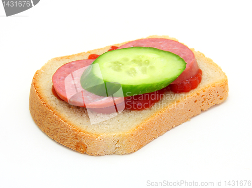 Image of sandwich with Ketchup sausage and a cucumber 