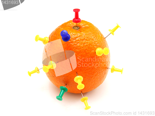 Image of Isolated colourful office pins thrust in an orange