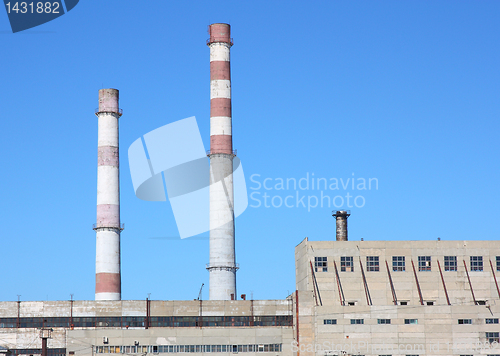 Image of chimneys  large plant against the blue sky