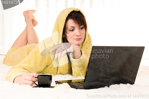 Image of woman with laptop and cup