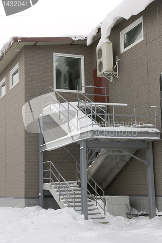 Image of Ladder in snow on the second floor with windows